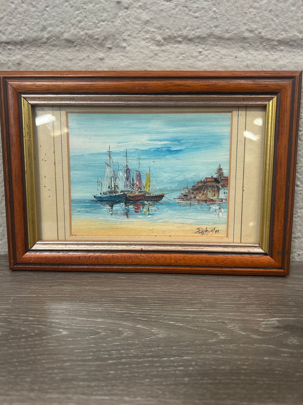 Vintage framed oil painting of a water front scene